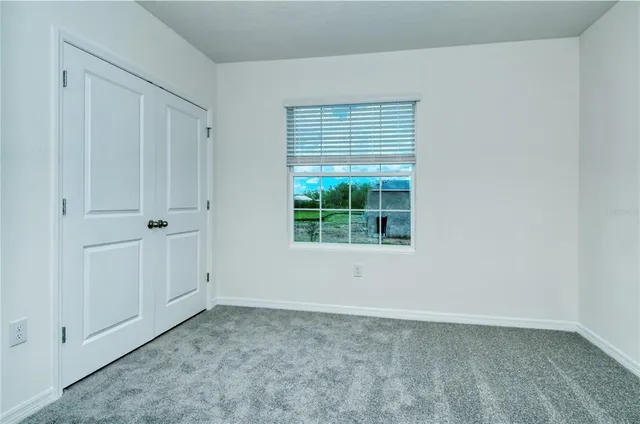 a view of an empty room with closet area