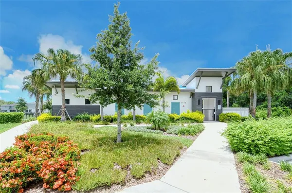 a view of a house with a swimming pool and a yard