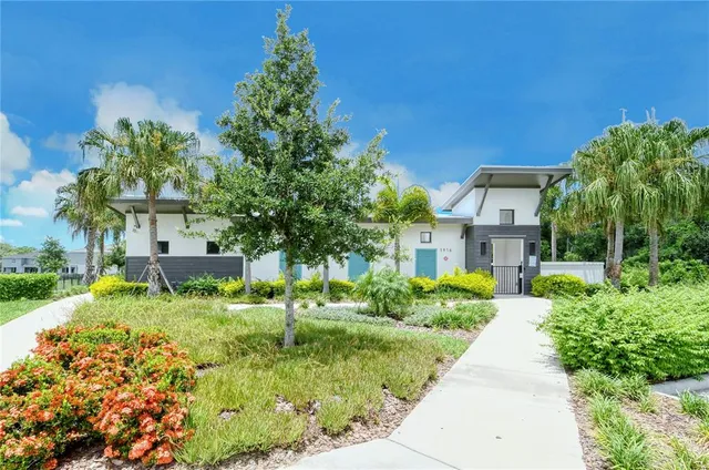 a view of a house with a swimming pool and a yard