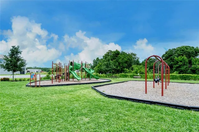 a view of a park with large trees and a park