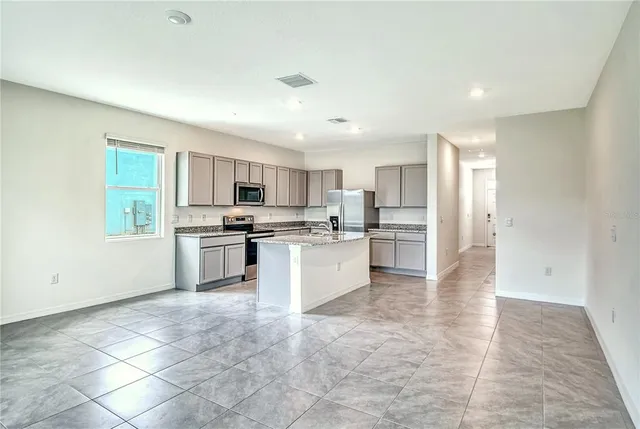 a large kitchen with cabinets and stainless steel appliances