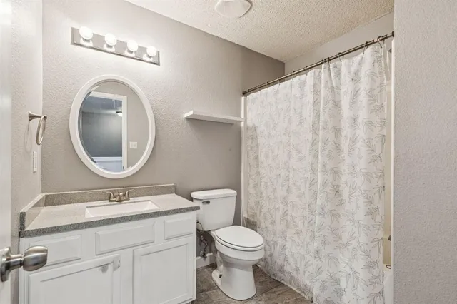 a bathroom with a toilet a sink and a mirror