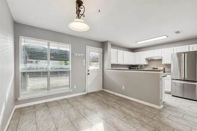 a view of wooden floor and windows in a room
