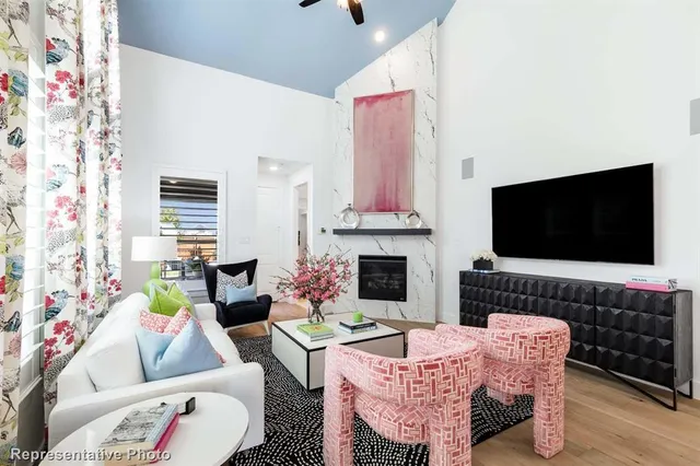a living room with furniture a flat screen tv and a fireplace