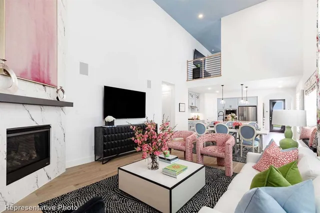 a living room with furniture a flat screen tv and a fireplace