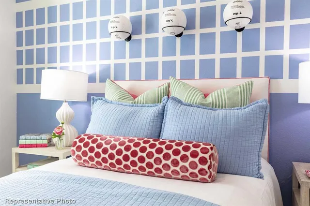 a bedroom with a bed and painting on the wall