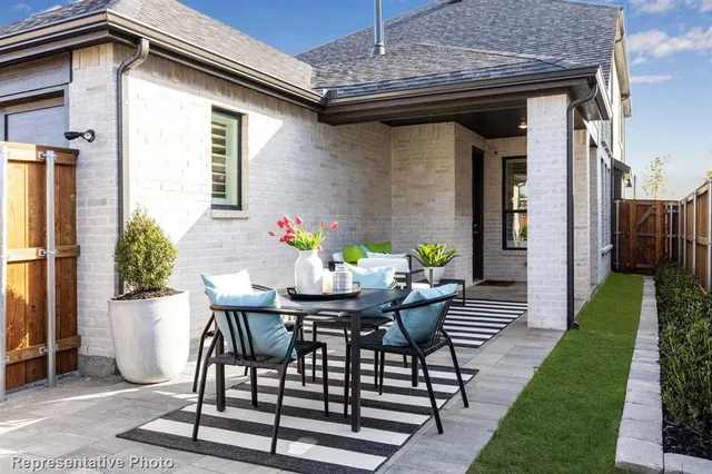 a view of a patio with table and chairs and potted plants