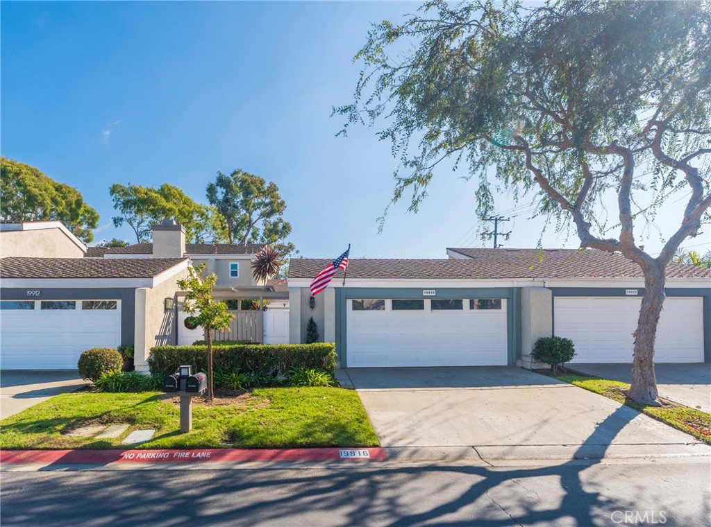 a front view of a house with a yard and a garage