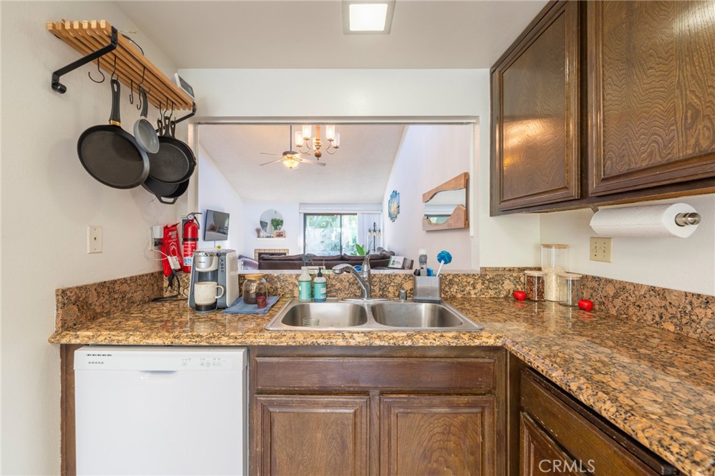 19916 Maritime Lane Huntington Beach, CA 92648 - Photo 12 of 43 a kitchen with a sink and a stove with wooden floor
