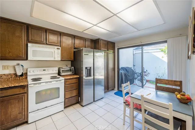 a kitchen with stainless steel appliances a stove refrigerator sink and cabinets