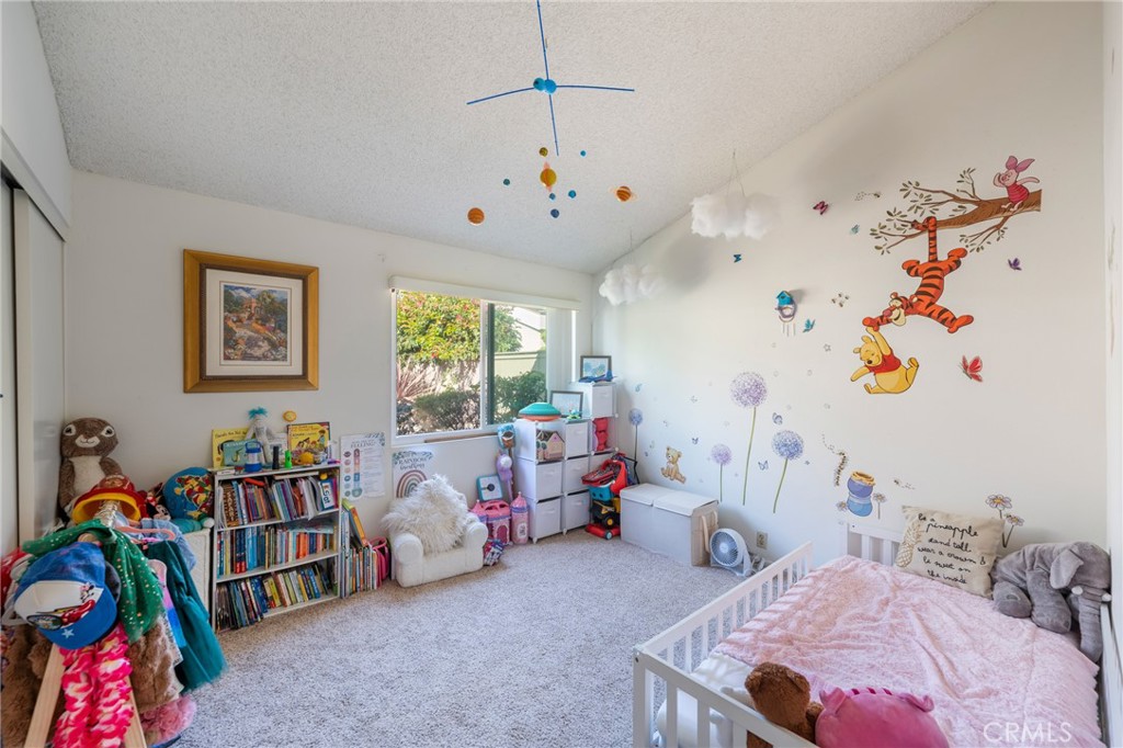 19916 Maritime Lane Huntington Beach, CA 92648 - Photo 14 of 43 a bedroom with furniture and a book shelf