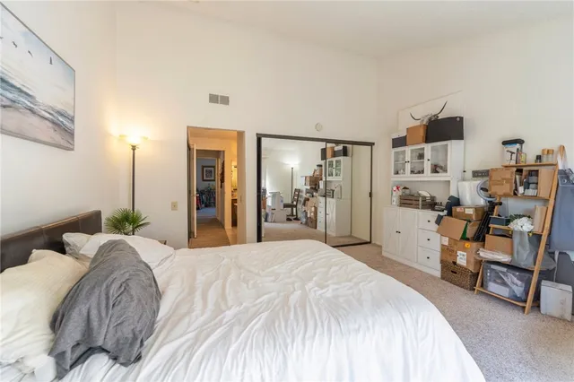 a spacious bedroom with a bed and a cabinets
