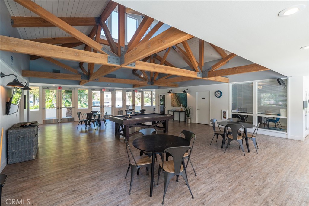 19916 Maritime Lane Huntington Beach, CA 92648 - Photo 35 of 43 a dining room with wooden floor a chandelier a wooden table and chairs