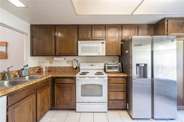 a kitchen with a stove sink and refrigerator