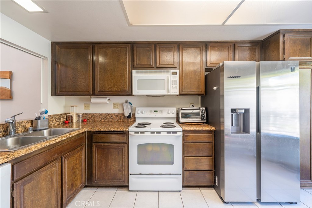 19916 Maritime Lane Huntington Beach, CA 92648 - Photo 10 of 43 a kitchen with a stove sink and refrigerator