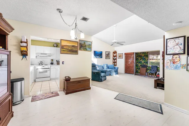 a living room with furniture and a ceiling fan