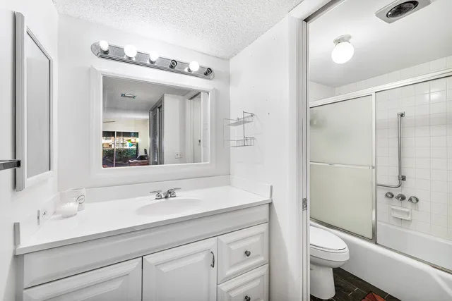 a view of a patio with table and chairs and potted plants