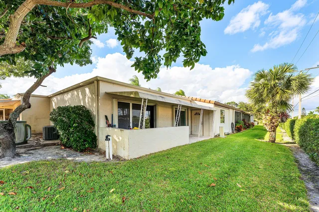 an aerial view of a house with a garden and swimming pool