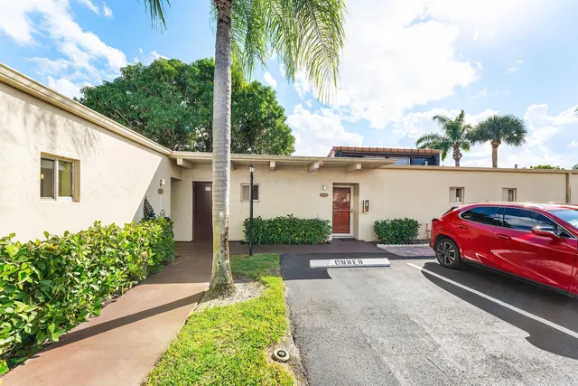 a view of a car park in front of a house