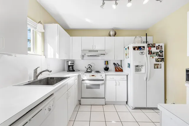 a kitchen with a sink cabinets and appliances