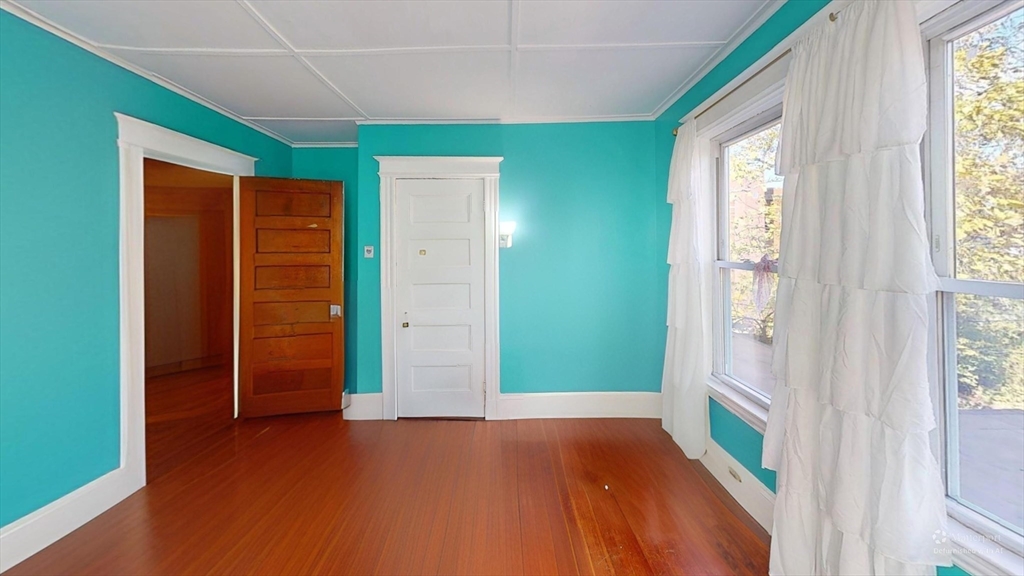 19 Mt Ida Road Boston, MA 02122 - Photo 21 of 36 an empty room with closet and windows