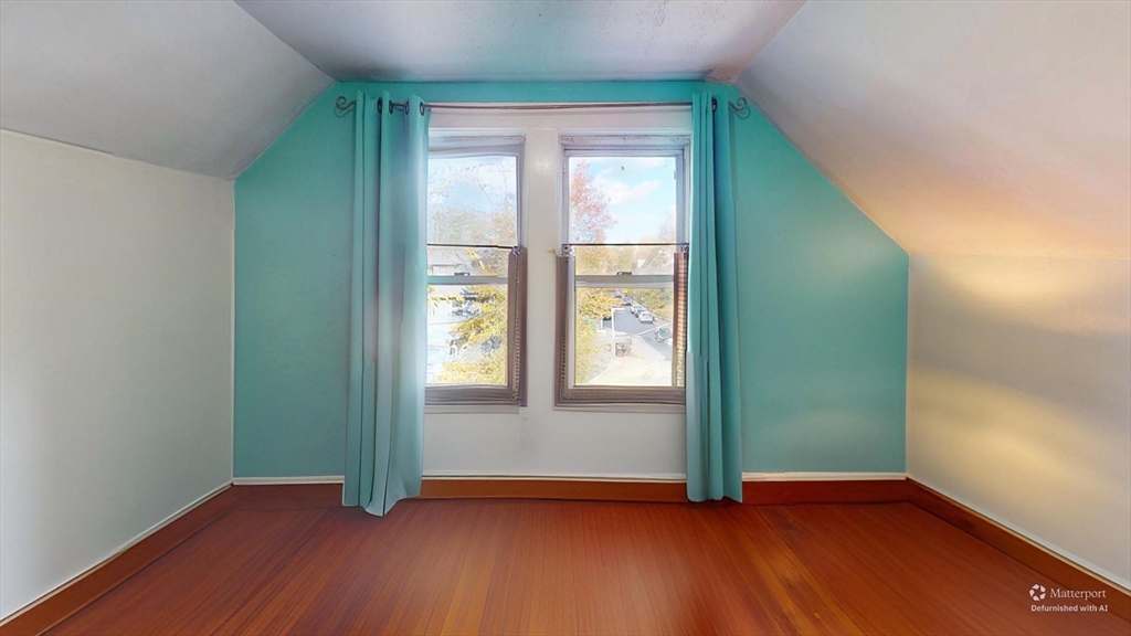 19 Mt Ida Road Boston, MA 02122 - Photo 28 of 36 an empty room with wooden floor closet and windows