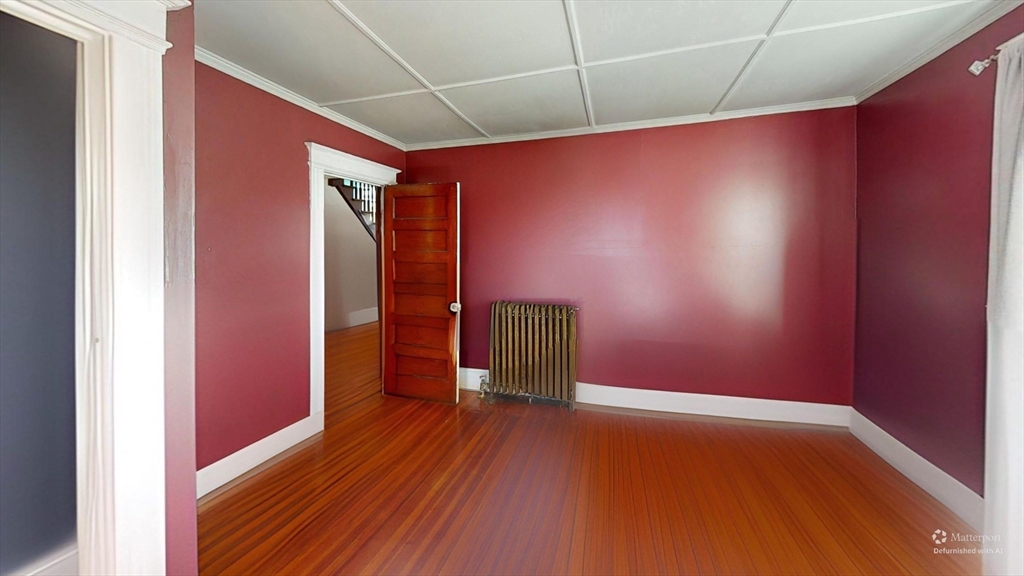 19 Mt Ida Road Boston, MA 02122 - Photo 32 of 36 a view of an empty room with wooden floor