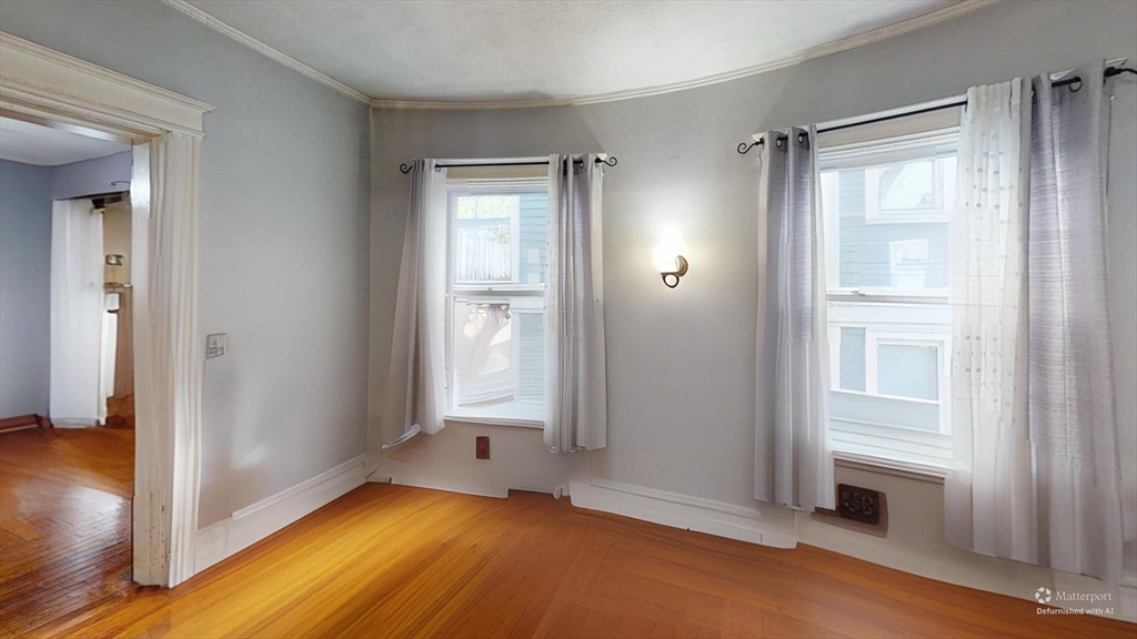 19 Mt Ida Road Boston, MA 02122 - Photo 33 of 36 a view of empty room with wooden floor and fan