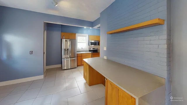 a kitchen with a sink and a refrigerator