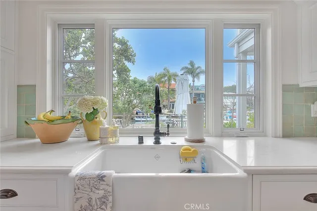 a kitchen with stainless steel appliances granite countertop a stove and a large window