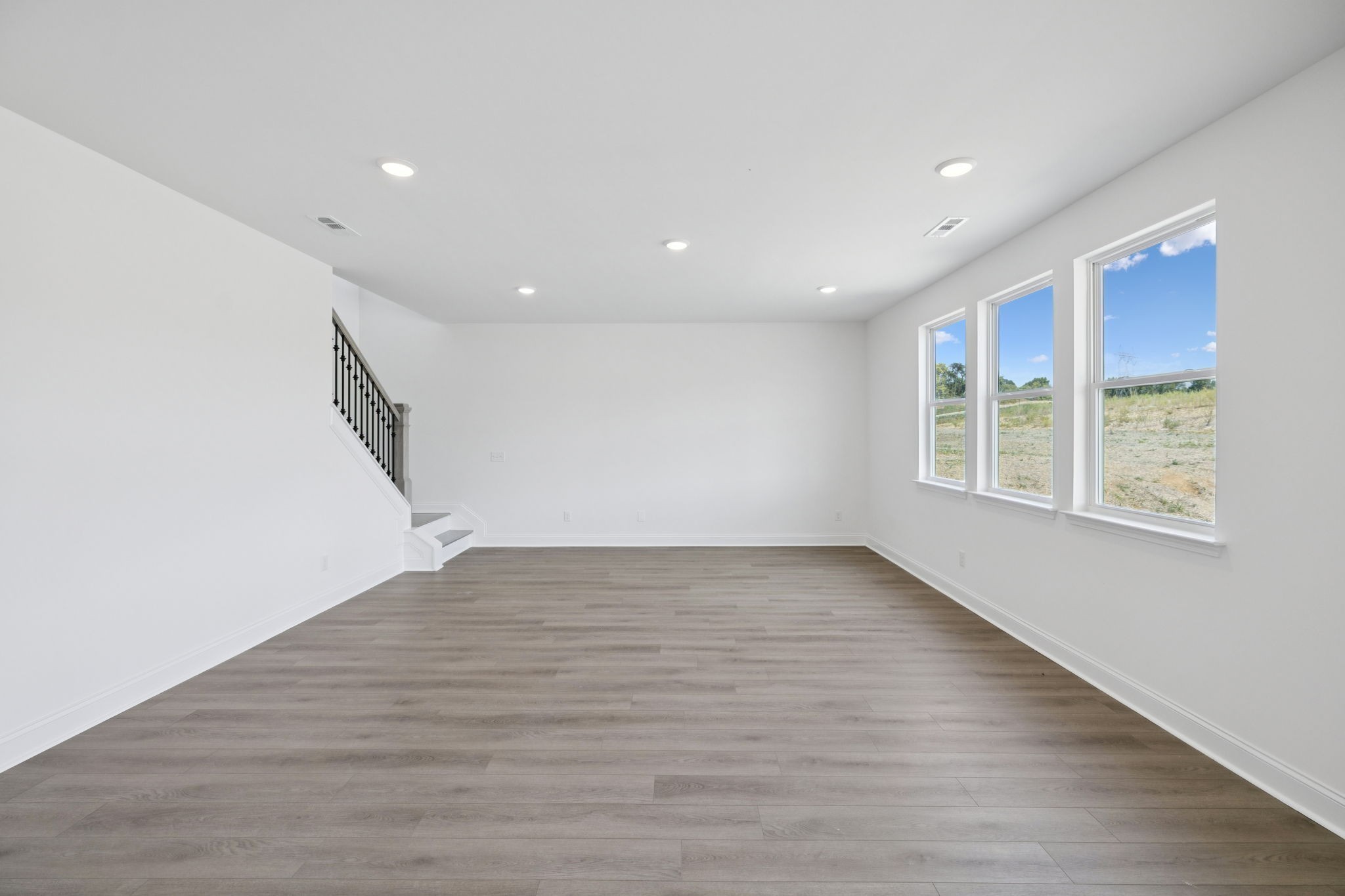 140 Emeline Way Mount Juliet, TN 37122 - Photo 11 of 35 a view of an empty room with wooden floor and a window