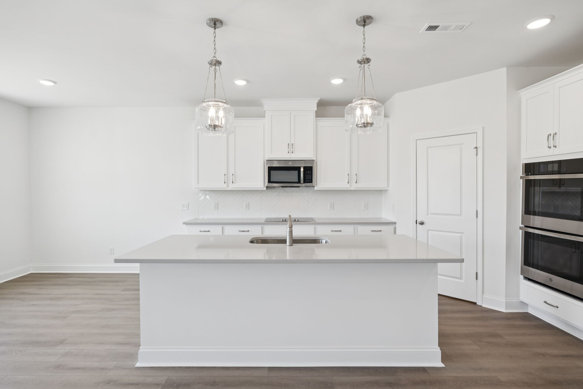 140 Emeline Way Mount Juliet, TN 37122 - Photo 7 of 35 a kitchen with kitchen island white cabinets and stainless steel appliances