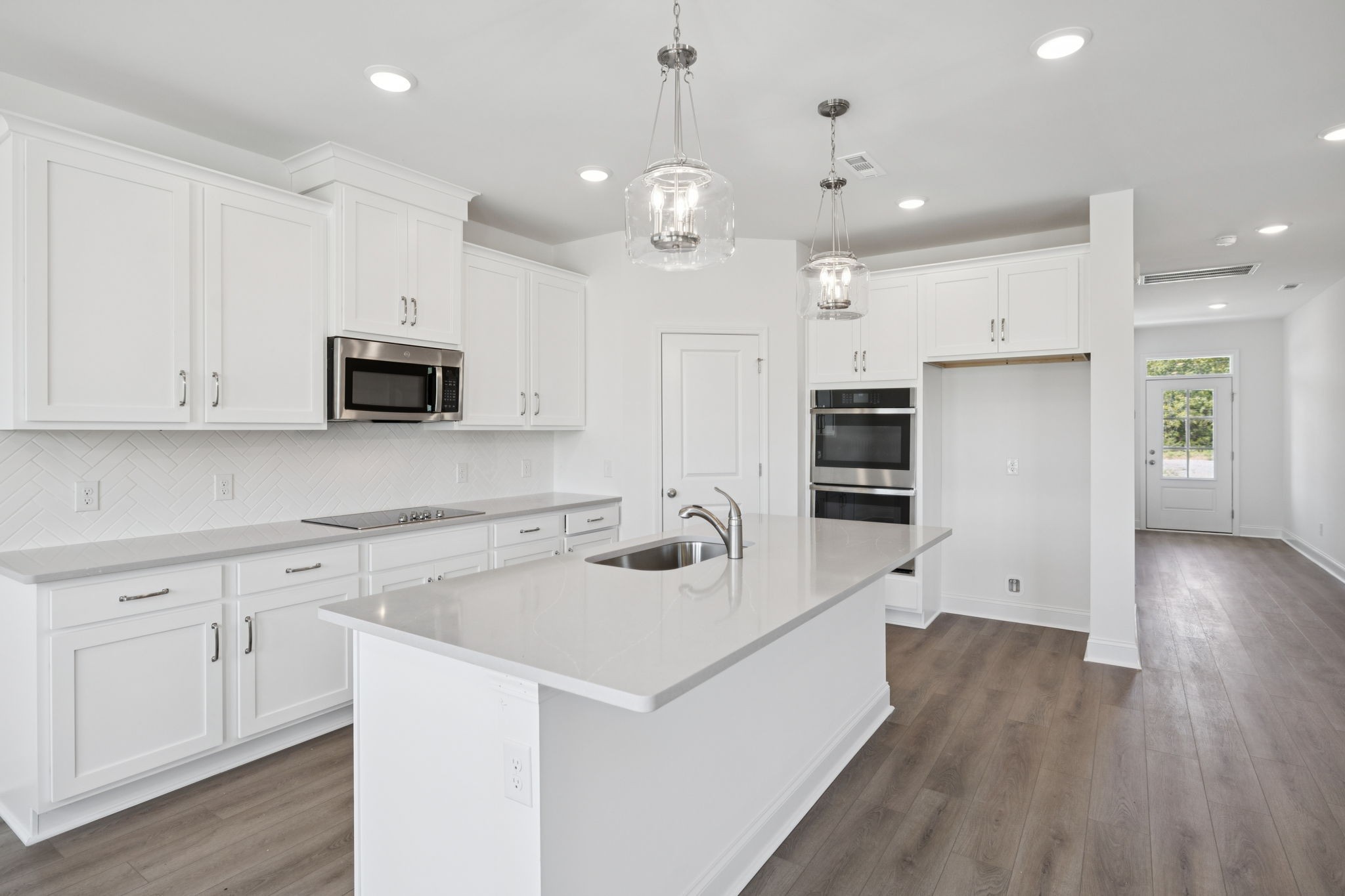 140 Emeline Way Mount Juliet, TN 37122 - Photo 8 of 35 a kitchen with a sink a microwave a stove and refrigerator