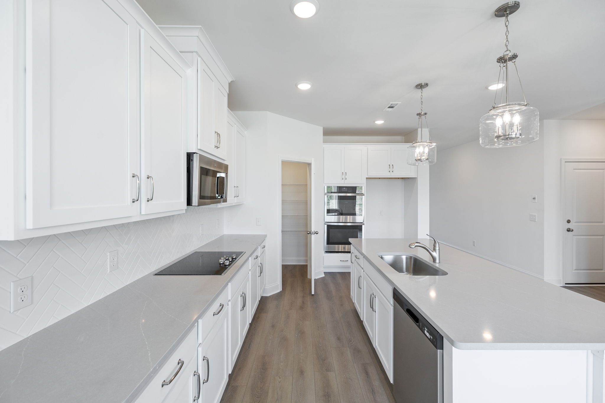 140 Emeline Way Mount Juliet, TN 37122 - Photo 10 of 35 a large white kitchen with stainless steel appliances granite countertop a lot of counter space and wooden floor