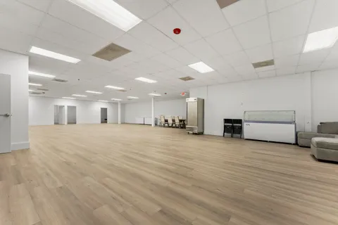 a view of a room with furniture and window