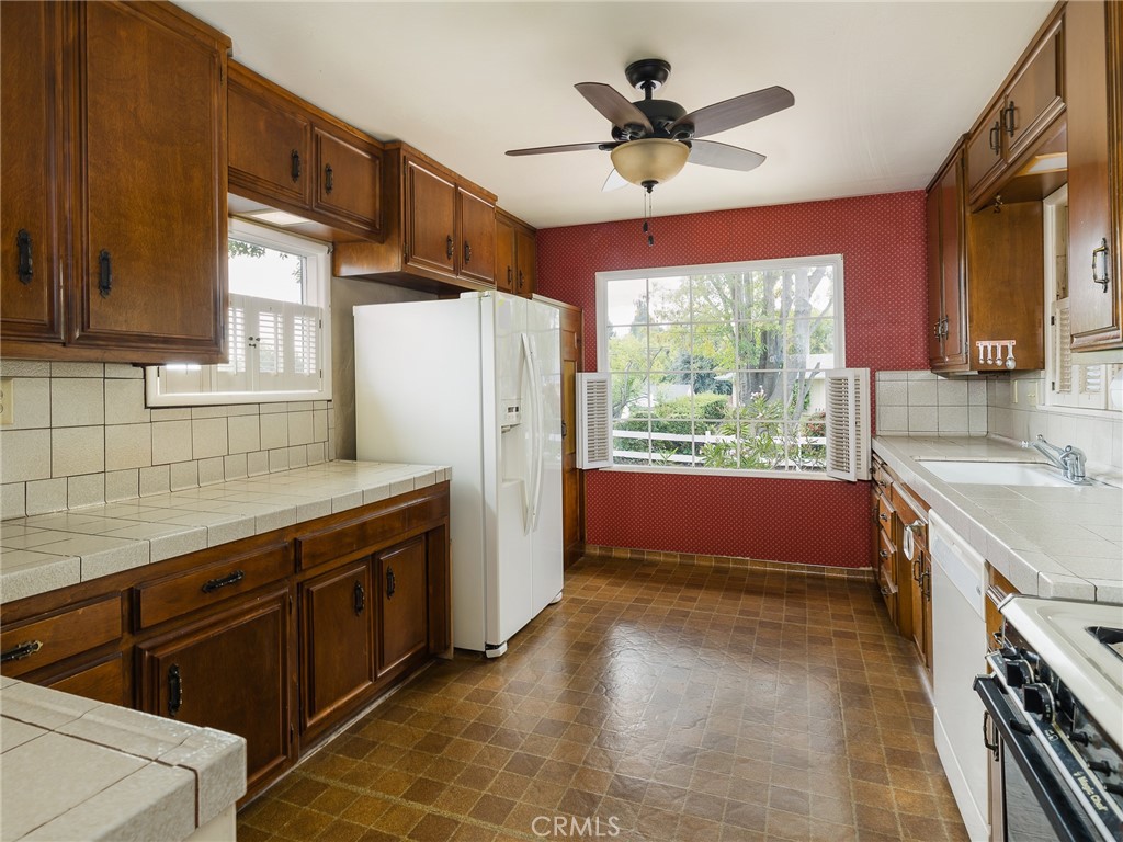61 Ranchview Road Rolling Hills Estates, CA 90274 - Photo 16 of 44 a kitchen with refrigerator cabinets and a large window