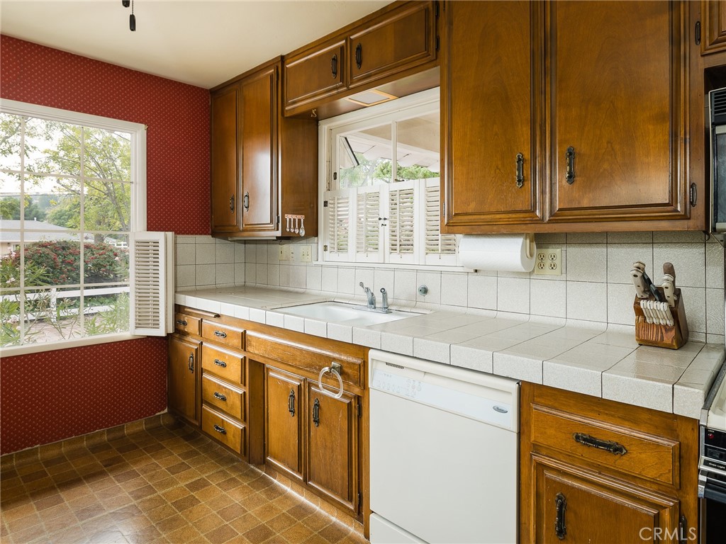 61 Ranchview Road Rolling Hills Estates, CA 90274 - Photo 17 of 44 a kitchen with stainless steel appliances granite countertop a sink and a stove next to a window
