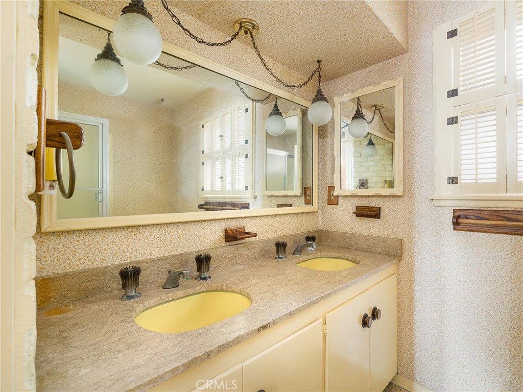 61 Ranchview Road Rolling Hills Estates, CA 90274 - Photo 25 of 44 a bathroom with a granite countertop sink and a mirror