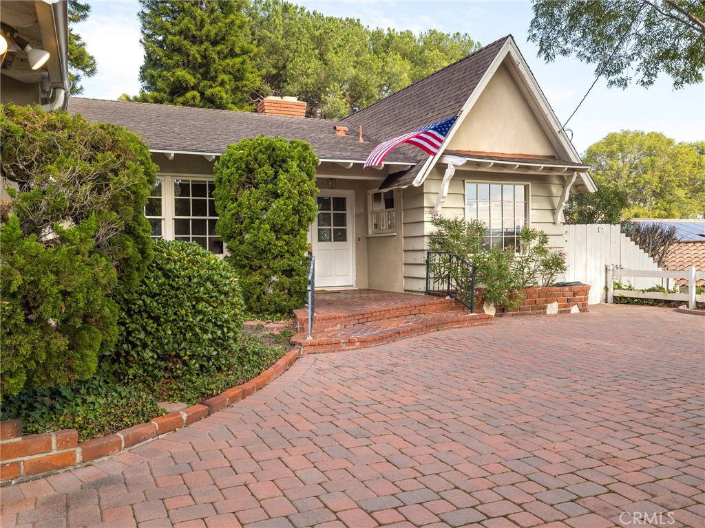 61 Ranchview Road Rolling Hills Estates, CA 90274 - Photo 4 of 44 a front view of a house with a yard and potted plants