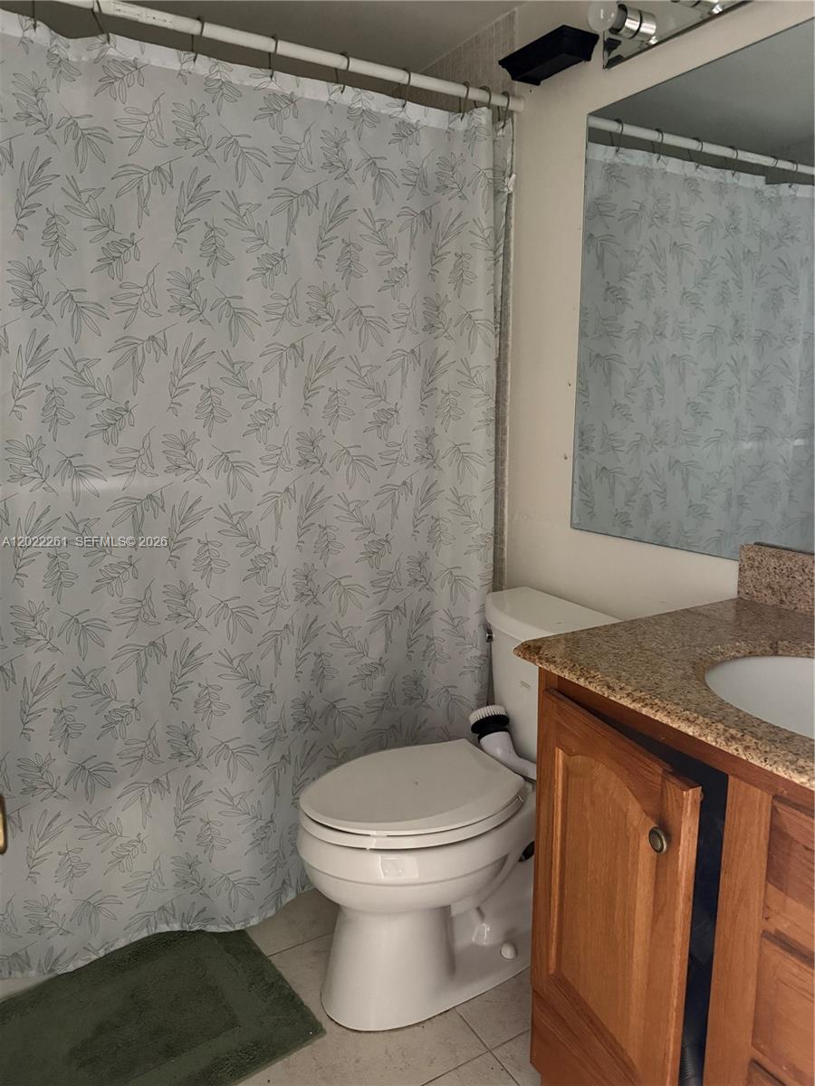 4043 Cornwall C, Unit 4043 Boca Raton, FL 33434 - Photo 5 of 16 a white toilet sitting next to a shower
