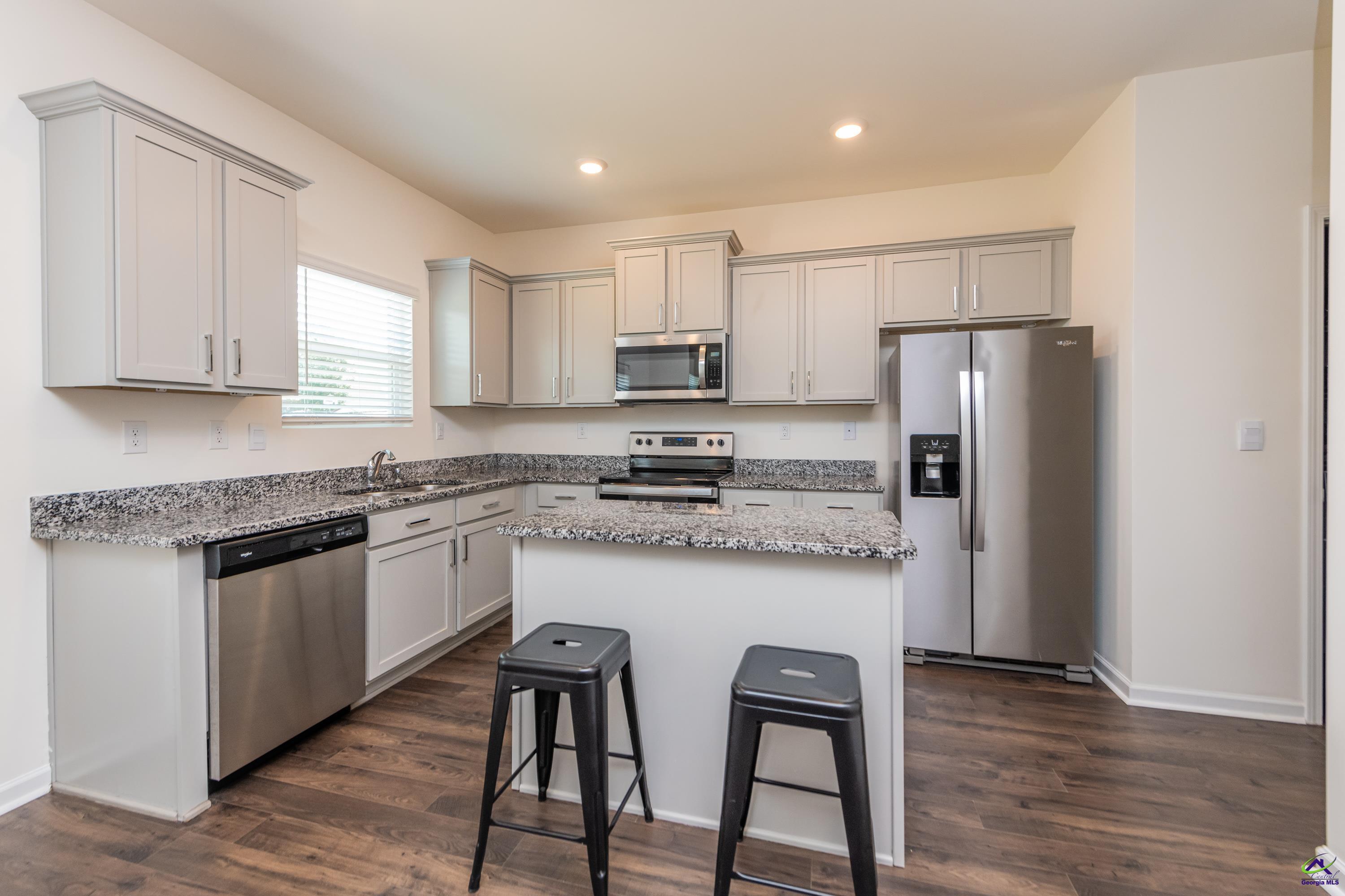126 Farmers Way Perry, GA 31069 - Photo 6 of 39 a kitchen with stainless steel appliances granite countertop a stove a refrigerator and a microwave