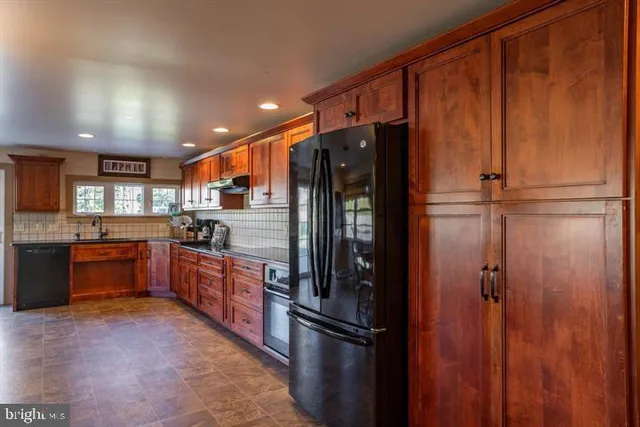 a dining room with stainless steel appliances a kitchen island a table and chairs