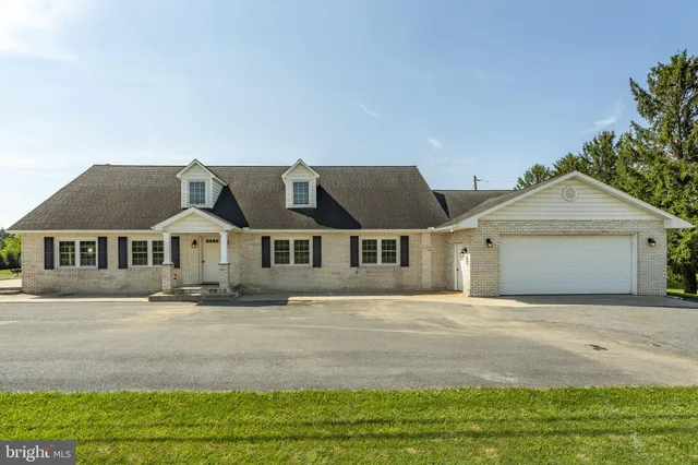 a front view of a house with a garden and yard