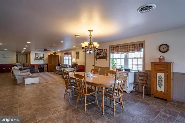 a view of a room with window and a chandelier fan