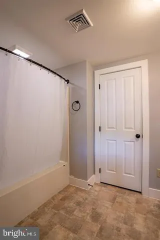 a view of living room with furniture and a chandelier