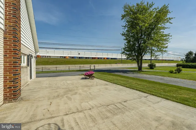 a view of a patio with table and chairs potted plants with wooden floor and fence