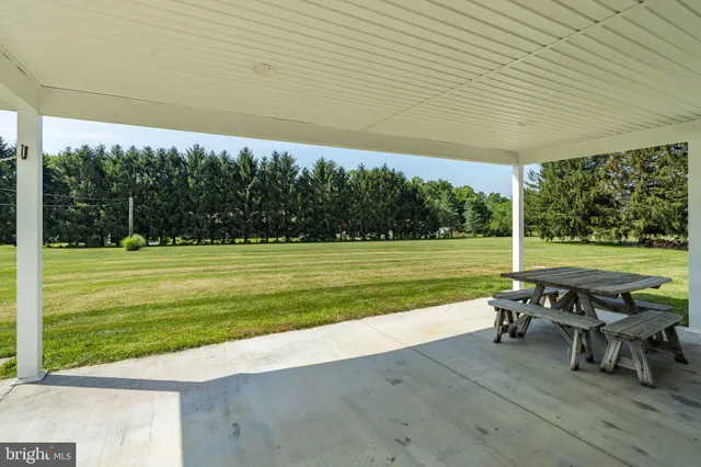 a front view of a house with a garden and patio