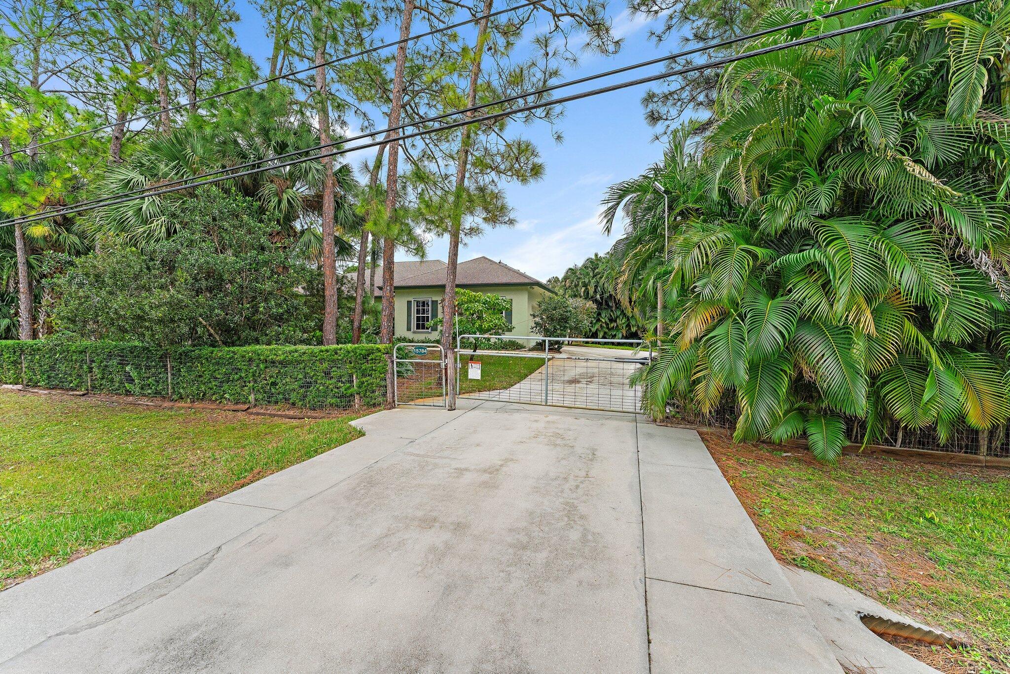 15784 Alexander Run Jupiter, FL 33478 - Photo 38 of 44 Electric gate w/ remote