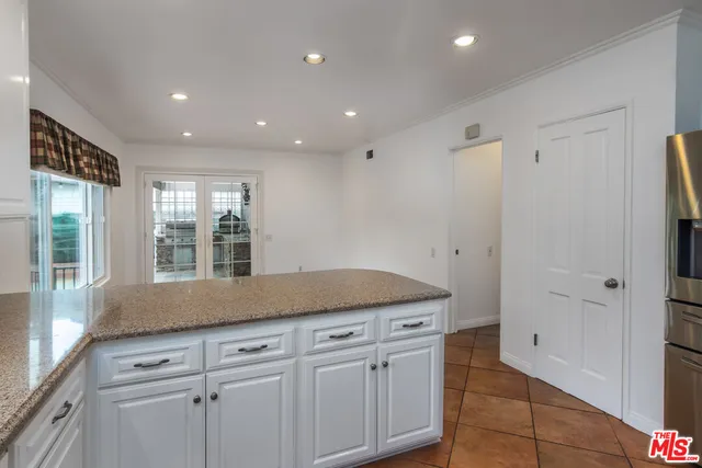 a view of a kitchen cabinets and a window