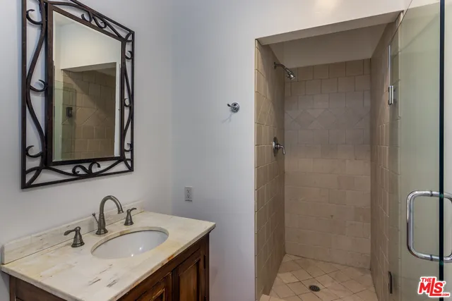 a bathroom with a sink vanity and a mirror